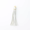 White faux leather tassel keychain with a polished gold metal cap for handbag accessories - Silver