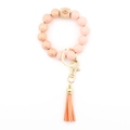 Pink orange beaded wristlet keychain with wooden bead and leather tassel - Peach