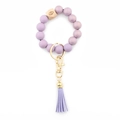 Lavender purple silicone beaded keychain bracelet with wooden charm and leather tassel - Purple