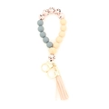 Portachiavi bracciale in silicone con nappa pesca, perla in legno e charm rosa a pois - Pesca