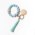 Macro shot of marble-textured silicone beads keychain with wood disk and mint green tassel - Blue and Purple Mix