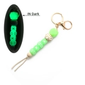 Glow in the dark silicone bead keychain with XO letter charms and beige suede tassel - Green