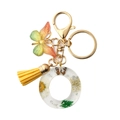 Resin letter O keychain with dried daisy, yellow tassel and green butterfly charm - Letter O