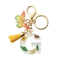 Resin letter G keychain with dried flowers, yellow tassel and butterfly pendant - Letter G