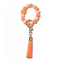 Luminous silicone bead keychain bracelet with orange and pink tones and a leather tassel - Peach