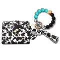 Cow print wristlet keychain with teal silicone beads and Mama wood charm - Green