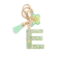 Macro detail of green resin letter E keychain with sequins, butterfly and tassel - 8-Loop Clasp + Butterfly / Letter E