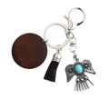 Bohemian eagle keychain with dark wood disc, black tassel, and turquoise stone - Black