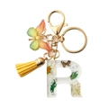 Resin letter R keychain with real dried flowers, silver flakes, and a yellow tassel - Letter R