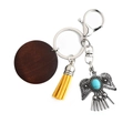 Bohemian eagle keychain with brown wood disc, yellow tassel and turquoise charm - Yellow