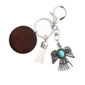 Bohemian silver eagle keychain with dark wood circle, white fringe, and turquoise stone - White