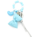 Detail of light blue silicone bead keychain with leather heart and bow charm accents - Blue