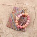 Flat lay of woven texture card wallet with gradient silicone bead tassel keychain - Woven Pink