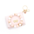 Set portafoglio in pelle rosa con fiocco dorato e portachiavi a cuore in silicone - Rosa
