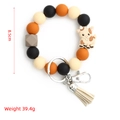 Porte-clés en perles de silicone avec breloque vache et pompon en noir et orange - Chèvre Beige