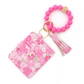 Dettaglio porta carte a fiori rosa con cinturino in silicone e nappa in metallo oro - Rosa e Rosso Rosa