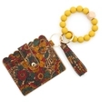 Tarjetero de corcho con pulsera de cuentas de silicona amarillas y estampado floral - Planta de Jengibre