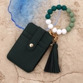 Detail of dark green pebble leather card holder with silicone bead wristlet and gold hardware - Dark Ink Green