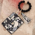Floral printed wallet with black silicone bead bracelet and tassel keychain set - Black