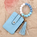 Detail of light blue faux leather card holder with silicone bead wristlet and tassel - Light Blue