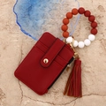 Red pebbled leather card wallet with colorful silicone bead bracelet and gold hardware - Dark Red