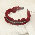 Close-up of red velvet pleated headband with crystal rhinestone inlay on white fabric - Pleated Edge Stripe Rhinestone Burgundy