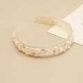 Detail shot of baroque style headband with pearls and rhinestones on beige fabric - Clear Base Pink