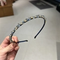 Exquisite navy blue crystal headband with hand-held showcase in a retail setting - Blue