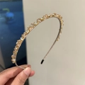 Handheld view of a slim headband with amber and clear crystals for women's hair styling - Champagne