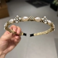 Close-up of golden headband featuring vintage pearls and clear crystals detailing - Teardrop Pearl