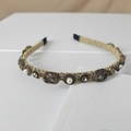 Detailed macro of vintage gold mesh headband featuring pearls and faceted rhinestones - Grey Oval Gemstone