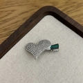 Detailed close-up of a silver heart hair clip with shimmering rhinestones on a linen tray - White Heart Charm