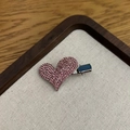 Detailed view of sweet pink rhinestone heart hair clip on a premium wooden display tray - Heart Pink
