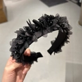 Detail view of handmade black mesh flower headband with beaded accents and crystal fringe - Black