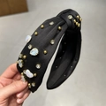 Detailed texture of black fabric headband with gold beads and sparkling rhinestones - Black