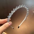 Close-up of elegant crystal beaded headband with shimmering faceted glass beads - Light Blue