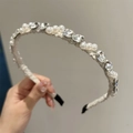 Close-up of elegant headband featuring sparkling rhinestones and white pearls detail - Off White