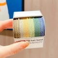 Close-up of spiral elastic hair bands in colorful gradient set with durable woven texture - Screw Back