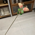 Detail view of a butterfly hairpin with pink-orange gradient wings and green leaf accents - Pink Hair Stick