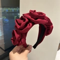 Detail of dark red handcrafted oversized fabric roses on a textured wide headband - Burgundy