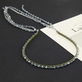 Detail of beaded headband featuring gradient blue crystals and olive green velvet ribbon - Olive Green