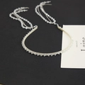 Detail of crystal headband with long beaded fringe tassels on a black background - Clear White