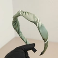 Detail of elegant bean paste green pleated satin headband with white pearl accents - Green