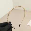 Detailed view of champagne crystal beaded headband with shimmering rhinestones and soft silk wrap - Champagne