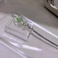 Close-up of silver branch hair pin with green cat eye stones and enamel accents - Hair Stick