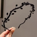 Detail of handcrafted black beaded headband featuring woven design and glossy glass crystals - Black