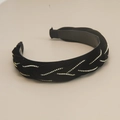 Close-up of black velvet braided headband with sparkling rhinestone wavy patterns - Black