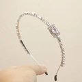 Elegant thin silver metal headband with clear crystals and a pink oval center stone - Pink