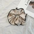 Detailansicht des champagnergoldenen Satin-Scrunchies mit zarten schwarzen Perlenbesätzen - Hellkhakifarbenes Scrunchie