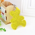 Detailed close-up of yellow rhinestone bear keychain with tassel and silver keyring - Yellow